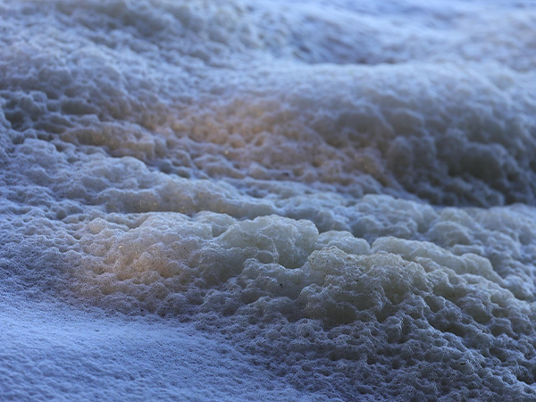 What is a defoamer and how does it work in the paper industry